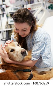 Therapy Dog Visiting Young Female Patient In Hospital