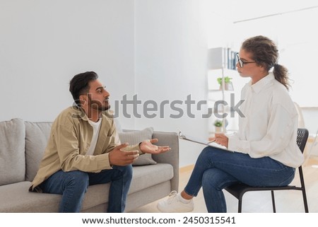 In a therapy session a young man explains his perspective to a therapist, illustrating the dynamic in a marriage