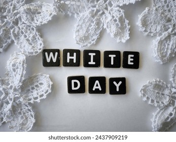 There are the alphabets;w,h,I,t,e,d,a and y surrounded with white flowers lace on the white background.