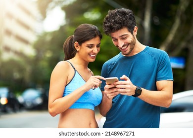 There are apps to keep track of your fitness routine. Shot of a sporty young couple using a cellphone while exercising outdoors. - Powered by Shutterstock