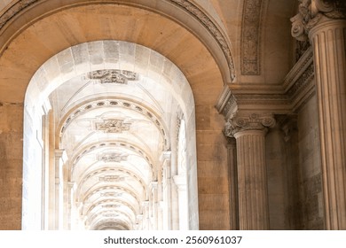 There is a beautifully designed long hallway featuring multiple arches and elegantly crafted columns within a historic building structure - Powered by Shutterstock