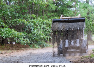 There Is A Bobcat Loader Tractor Moving And Unloading Gravel On An Old Road Reconstruction Project