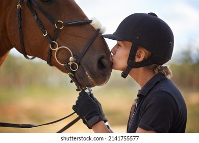 There is a bond between horse and rider. A young female rider being affectionate with her chestnut horse. - Powered by Shutterstock