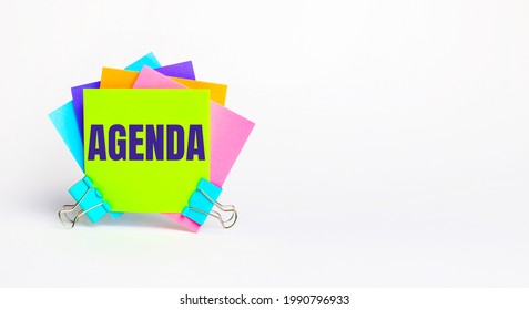 There are bright multi-colored stickers with the text AGENDA on a white background. Copy space
