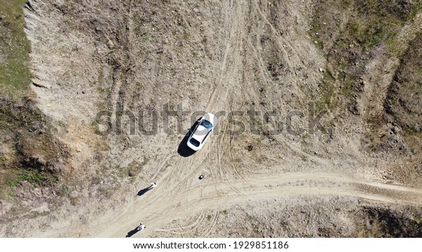 There is a car in\
valley. Drone view of car.\
