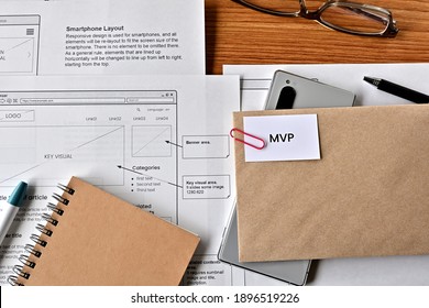 There Is Card With The Word MVP On It With Dummy Paper Of Design Of Web Systems.