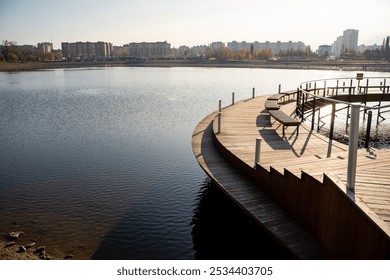 There is a charming wooden walkway that beautifully leads to a serene lake, all while a bustling cityscape can be seen in the background, providing a stunning contrast to the natural scenery - Powered by Shutterstock