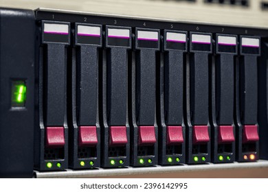 There is a close-up view of a server with many hard drives. - Shutterstock ID 2396142995