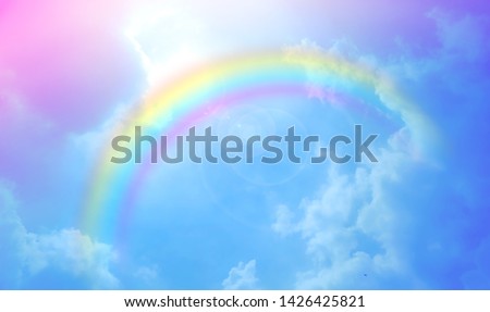 There are clouds and sky with rainbow as pastel background.