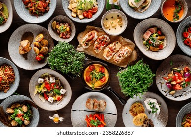 there are a lot of dishes on the wooden table. High quality photo