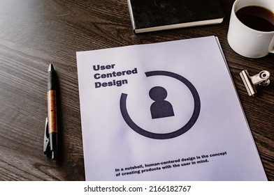 There is dummy documents that created for the photo shoot on the desk about User Centered Design.