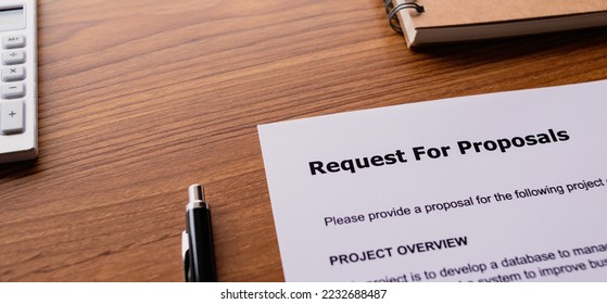 There is dummy documents that created for the photo shoot on the desk about Request For Proposal.