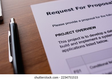 There is dummy documents that created for the photo shoot on the desk about Request For Proposal.