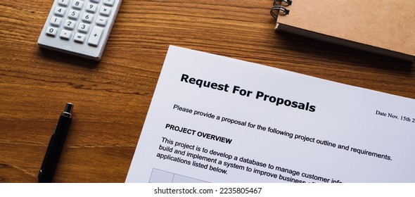 There is dummy documents that created for the photo shoot on the desk about Request For Proposal.