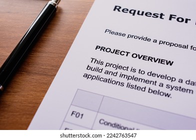There is dummy documents that created for the photo shoot on the desk about Request For Proposal.