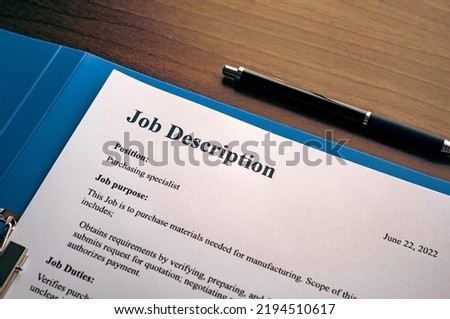 There is dummy documents that created for the photo shoot on the desk about Job Description.