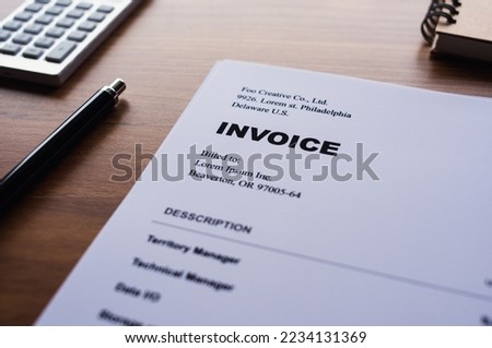 There is dummy documents that created for the photo shoot on the desk about INVOICE.