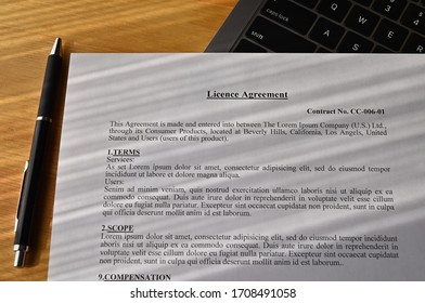 There is a dummy paper "Licence Agreement" with a laptop PC on the desk.