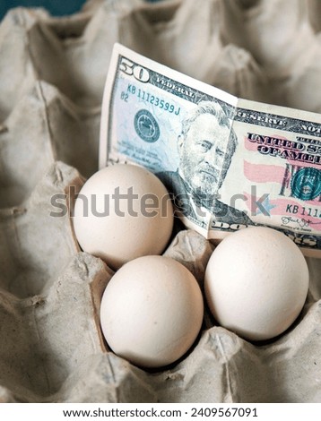 There are eggs in the egg carton and 100 dollars on it, implying an increase in egg prices,