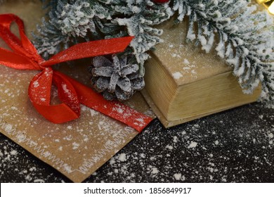 There Is An Envelope And A Book Under The Christmas Tree