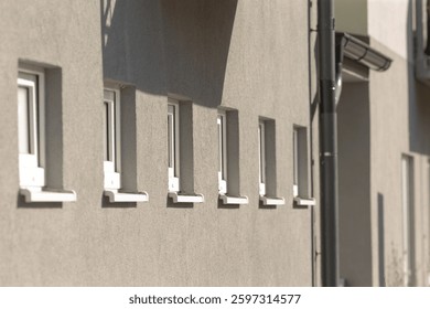 There exists a distinctive row of windows on the side of a particular building structure that enhances both its appearance and functionality