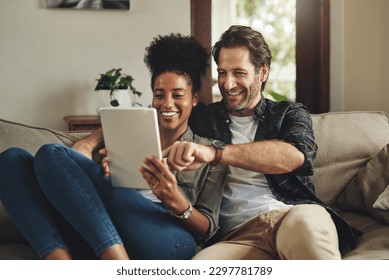 There are so many apps to choose from. a happy young couple using a digital tablet together while relaxing on a couch at home. - Powered by Shutterstock