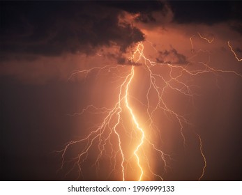 There are many lightning bolts against the black sky. Night photo of a thunderstorm on a long exposure, close up. A composite image of several frames. Copy space, an effect for design and overlay.