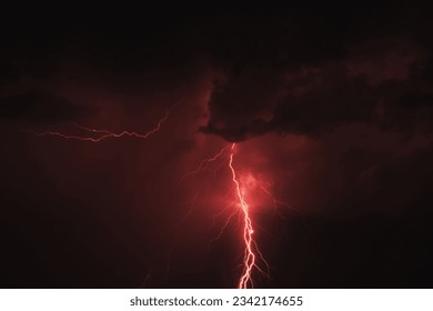 There are many lightning bolts against the black sky. Night photo of a thunderstorm on a long exposure, close up. A composite image of several frames. Copy space, an effect for design and overlay. - Powered by Shutterstock