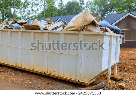 There is metal container dumpster for construction waste