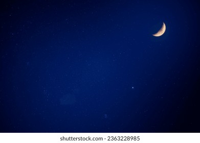 There are moon and stars in the blue sky. Slow exposure photography. Clear night sky in summer, New Taipei City, Taiwan