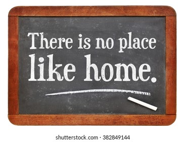 There is no place like home proverb white chalk text on a vintage slate blackboard