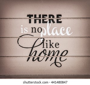 There is no place like home. Title on the wooden background. Symbolic inscription.