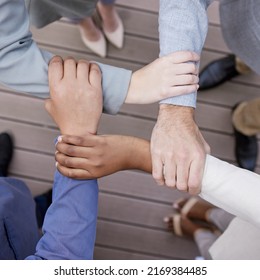 There Is No Weak Link Here. Cropped Shot Of A Group Of Unrecognizable Businesspeople Linking Arms.