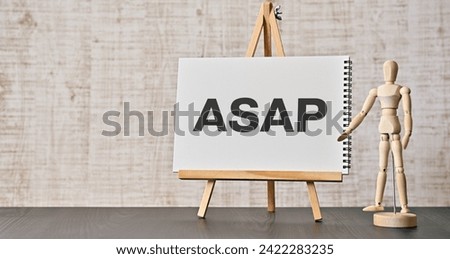 There is notebook with the word ASAP. It is an abbreviation for As soon as possible as eye-catching image.