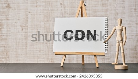 There is notebook with the word CDN. It is an abbreviation for Content Delivery Network as eye-catching image.
