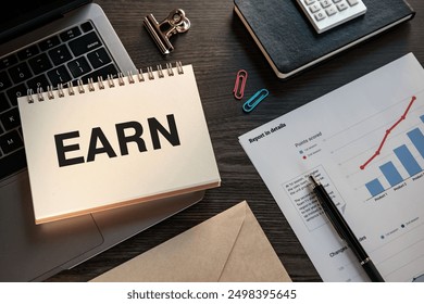 There is notebook with the word EARN. It is as an eye-catching image.