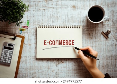 There is notebook with the word e-Commerce. It is as an eye-catching image.