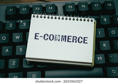 There is notebook with the word e-Commerce. It is as an eye-catching image.