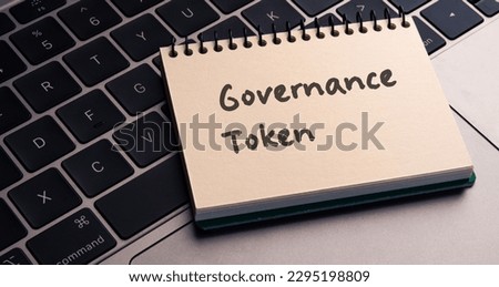 There is notebook with the word Governance Token.It is as an eye-catching image.