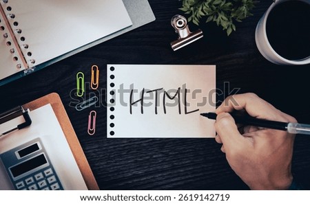 There is notebook with the word HTML. It is an abbreviation for Hyper Text Markup Language as eye-catching image.