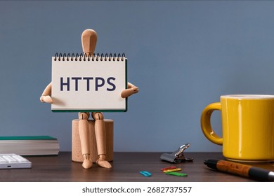 There is notebook with the word HTTPS. It is an abbreviation for Hypertext Transfer Protocol Secure as eye-catching image.