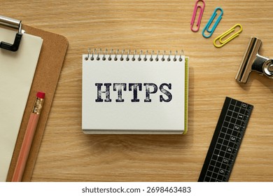 There is notebook with the word HTTPS. It is an abbreviation for Hypertext Transfer Protocol Secure as eye-catching image.