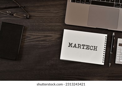There is notebook with the word MARTECH. It is as an eye-catching image.