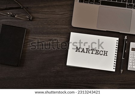 There is notebook with the word MARTECH. It is as an eye-catching image.