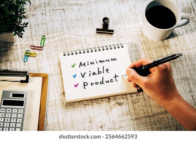 There is notebook with the word Minimum Viable Product. It is as an eye-catching image.