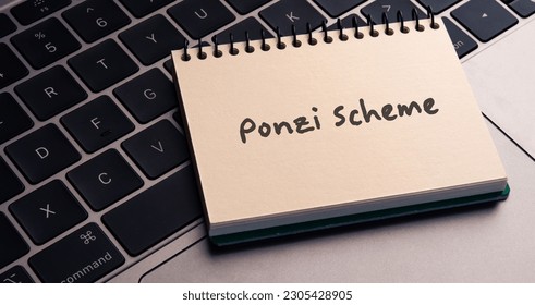 There is notebook with the word Ponzi Scheme.It is as an eye-catching image.