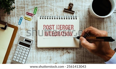 There is notebook with the word Post Merger Integration. It is as an eye-catching image.