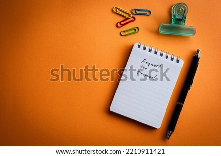 There is a notebook with the word Request for Proposal. It's placed on a color background.