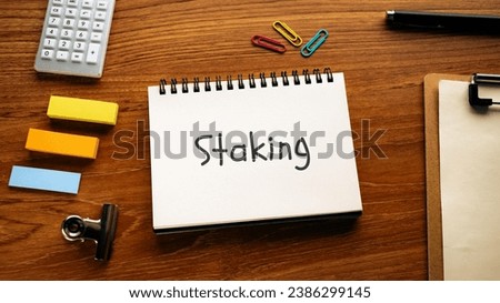 There is notebook with the word Staking. It is as an eye-catching image.