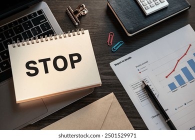 There is notebook with the word STOP. It is as an eye-catching image.